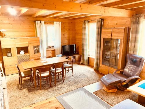 a dining room with a table and chairs in a cabin at Holidayhome Juksty in Mrągowo
