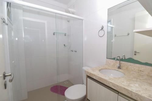a bathroom with a shower and a toilet and a sink at 377 - Belissimo apartamento na praia de Bombas in Bombinhas