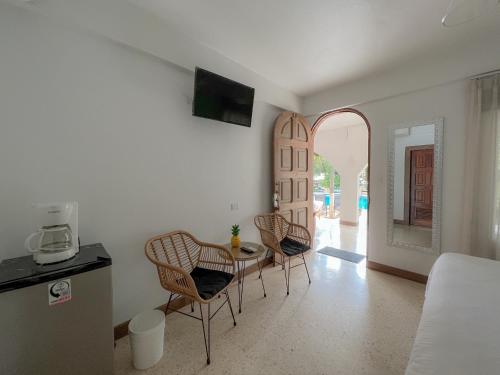 a living room with a table and chairs in a room at Hotel Mar Rey in Tamarindo