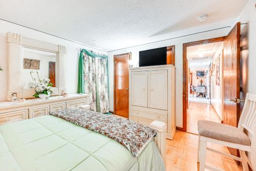 a bedroom with a bed and a television in it at Vintage Windsor Home Private Yard and Covered Deck in Windsor