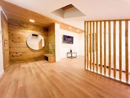 a room with wooden walls and a wooden floor at Wolf House BnB in Coppito