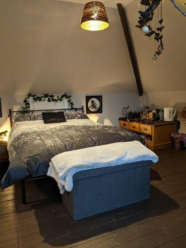 a bedroom with a large bed in a room at Yawl, Harcombe House in Uplyme