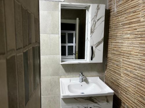 a bathroom with a sink and a mirror at Downtown Inn Madaba in Madaba