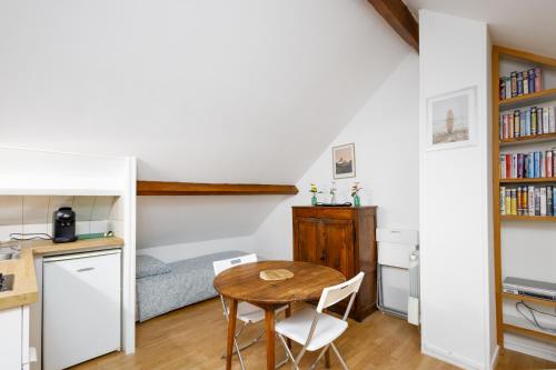 a small apartment with a table and a bed at Lovely apartment Deauville in Deauville