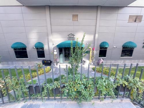 a building with a bunch of plants in front of it at YOUR HOUSE Apart Otel in Karaköprü Köyü
