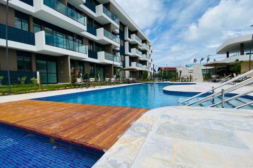a swimming pool in front of a building at Studio de Luxo em Muro Alto - Makia Beach A209 in Porto De Galinhas