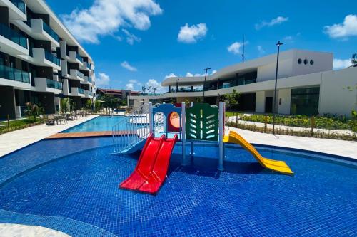 a playground in front of a apartment building at Studio de Luxo em Muro Alto - Makia Beach A209 in Porto De Galinhas