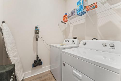 a white laundry room with a washer and dryer at Mins to the Beach/King Beds/Arcade-Snowbird Deals! in Perdido Key