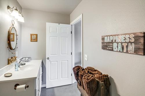 a bathroom with a sink and a mirror and a toilet at Downtown Del Norte Apartment Ski, Hike and Shop! in Del Norte