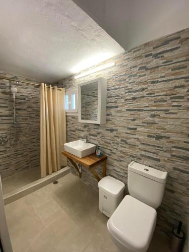 a bathroom with a toilet and a sink at Ios Village View in Ios Chora