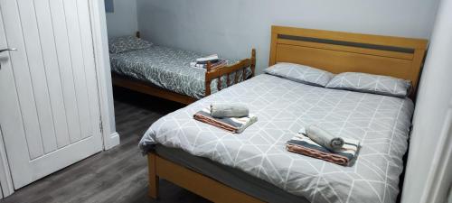 a bedroom with a bed with two towels on it at A Whole Terrace house to you in Distington
