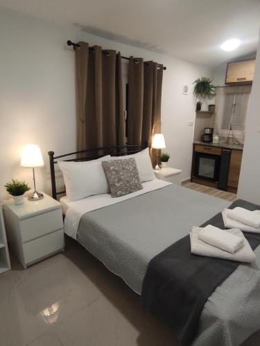 a bedroom with a large bed and two lamps at Johnson house in Rafina