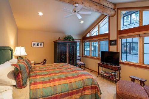 a bedroom with a bed and a flat screen tv at Ski Way Home Steps to the Warm Springs Lift in Ketchum