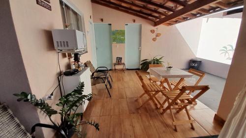 a room with a table and chairs and a television at Pousada Jeitim Mineiro in Capitólio