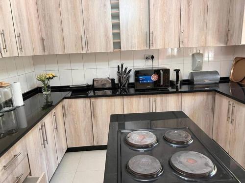 a kitchen with a stove top in a kitchen at Four m luxury Apartment. in Kitwe