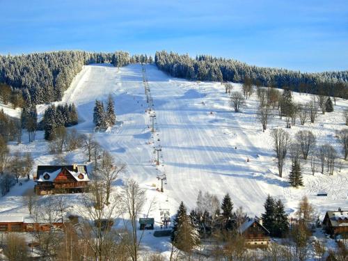 a snow covered ski slope with a ski lift at Residence Smržovka - Luxury House with Swimming Pool, Jacuzzi, Garden and BBQ in Jablonec nad Nisou