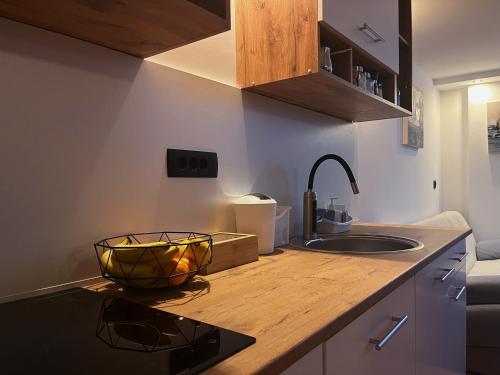 a kitchen with a sink and a counter top with a sink at Apartman LA CASA 77B in Ljubljana