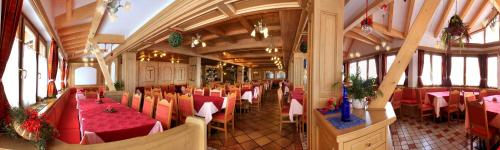 a dining room with tables and chairs in a building at Sporting Hotel in Passo del Tonale