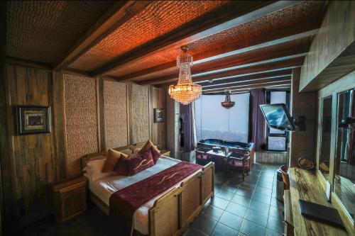 a bedroom with a large bed and a chandelier at Bay Lodge Boutique Hotel in Jounieh