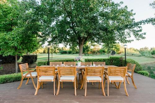 a long wooden table with chairs and a tree at Riverfront Beauty with Pickle Ball Court in Kingsburg