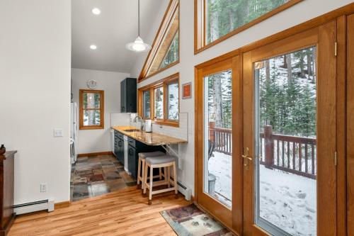 a kitchen with a view of a deck with windows at Mill Creek Cabin - Dumont in Dumont