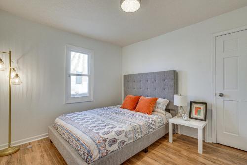 a bedroom with a bed with orange pillows and a window at Tranquil Fort Wayne Home 7 Mi to Downtown in Fort Wayne