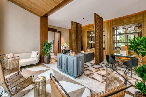 a living room with a couch and a table and chairs at Fairmont Tazi Palace Tangier in Tangier