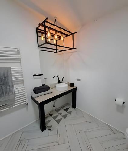 a bathroom with a sink and a light fixture at okeyloft Coyhaique 6 in Coihaique