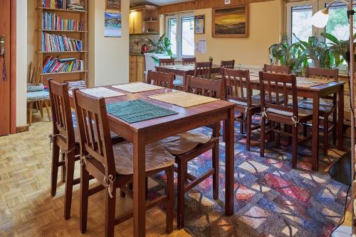 a dining room with wooden tables and chairs at Willa Potoki in Szklarska Poręba