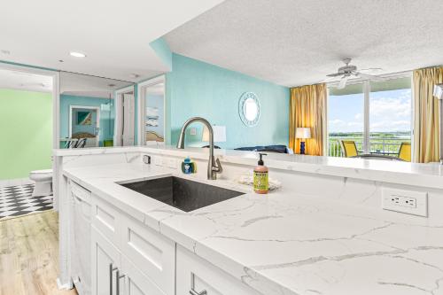 a kitchen with a sink and a counter top at Sunrise Suites Barbados Suite #204 in Key West