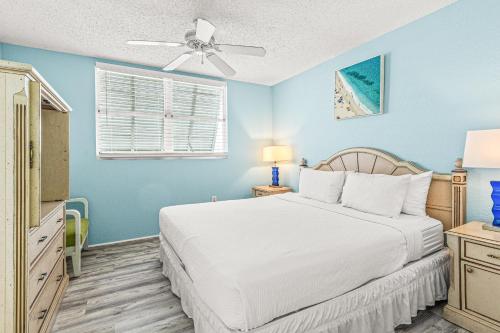 a bedroom with a bed and a ceiling fan at Sunrise Suites Barbados Suite #204 in Key West