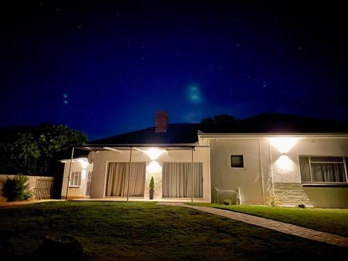 a house with lights on the side of it at night at Cradock Guest House in Cradock