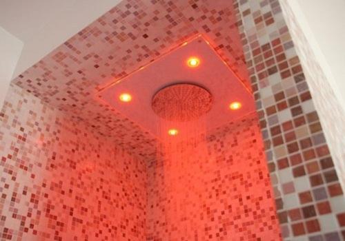 a bathroom with a red urinal on a wall at Sporting Hotel in Passo del Tonale