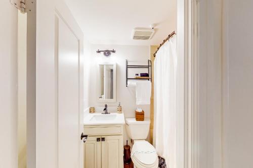 a bathroom with a white toilet and a sink at Sunrise Suite #2232 in Palm Beach