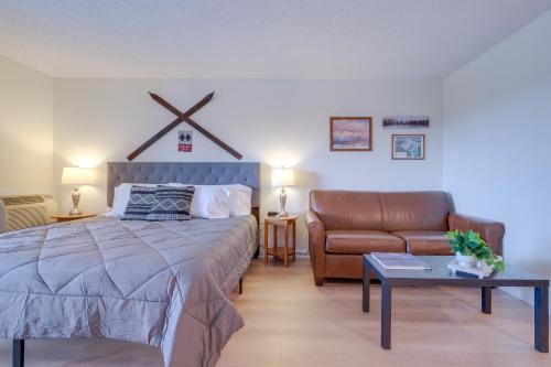 a bedroom with a bed and a couch at Bellaire Vacation Rental - Ski Shuttle Access! in Bellaire