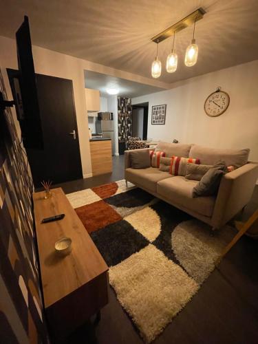 a living room with a couch and a table at Appartement t2 foirail étage in Espalion