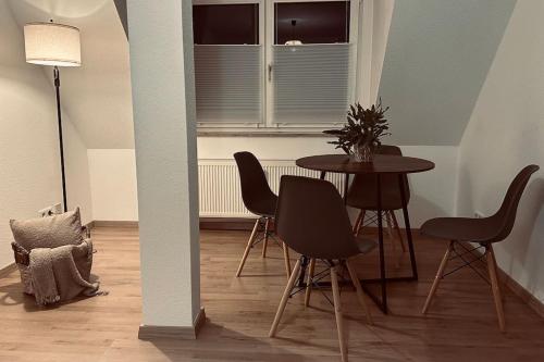 une chambre avec une table, des chaises et une fenêtre dans l'établissement Gemütliche Altstadtwohnung mit Balkon Smart-TV, à Erfurt