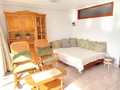 a living room with a couch and chairs at Tenerife Flamingo in Palm-mar