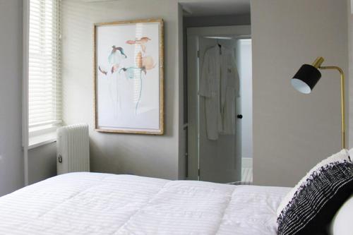 a bedroom with a bed and a picture of birds at The National Hotel in Frenchtown