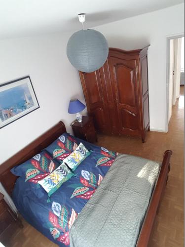 a bedroom with a bed with pillows on it at Belle Appartement in Auxerre
