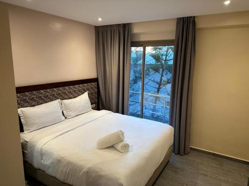 a hotel room with a bed with a window at Oceana Mazagan Suites Hotel in El Jadida