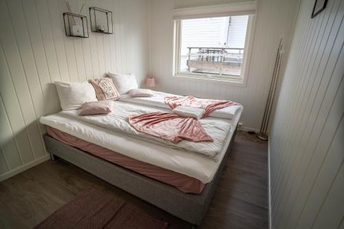 a bed in a room with a window at City Center Getaway 9 by Berti in Stavanger