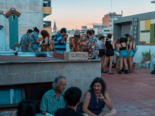 a group of people sitting on a building at Casabunda Multiespacio - Habitación privada in Salta