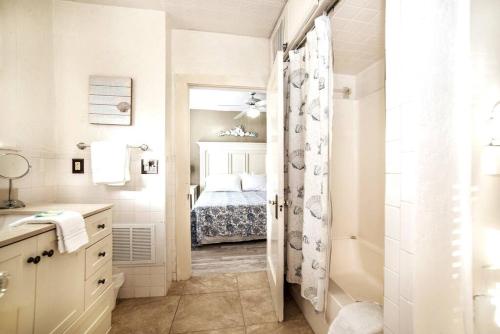 a bathroom with a bed and a shower and a sink at Beautiful Waterfront Beach Cottage. Sleeps 6 in Clearwater Beach