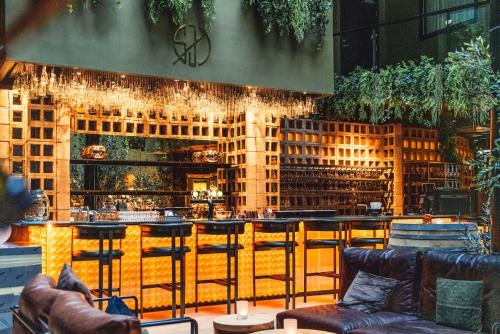 a bar with couches and chairs in a restaurant at Magic Hotel & Apartments Kløverhuset in Bergen