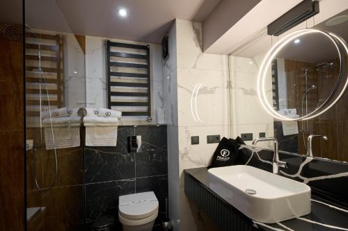 a bathroom with a sink and a toilet and a mirror at F&B Spa Resort (ex. Fomich Hotel) in Bukovel