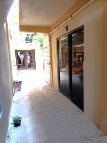 an entrance to a house with a sliding glass door at Beach Side Condos Caye Caulker by CCVH in Caye Caulker