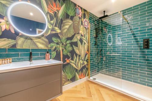 a bathroom with a mural of plants on the wall at Luxury holiday home near the coast in Porthtowan