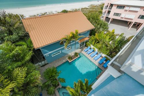 an aerial view of a resort with a swimming pool and palm trees at The Blue Horizon in Bradenton Beach