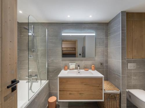 a bathroom with a sink and a shower and a mirror at Appartement Courchevel 1550, 4 pièces, 9 personnes - FR-1-562-75 in Courchevel